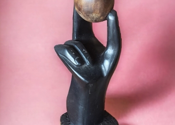 ARM-AFRICAN ARM HOLDING AN EGG